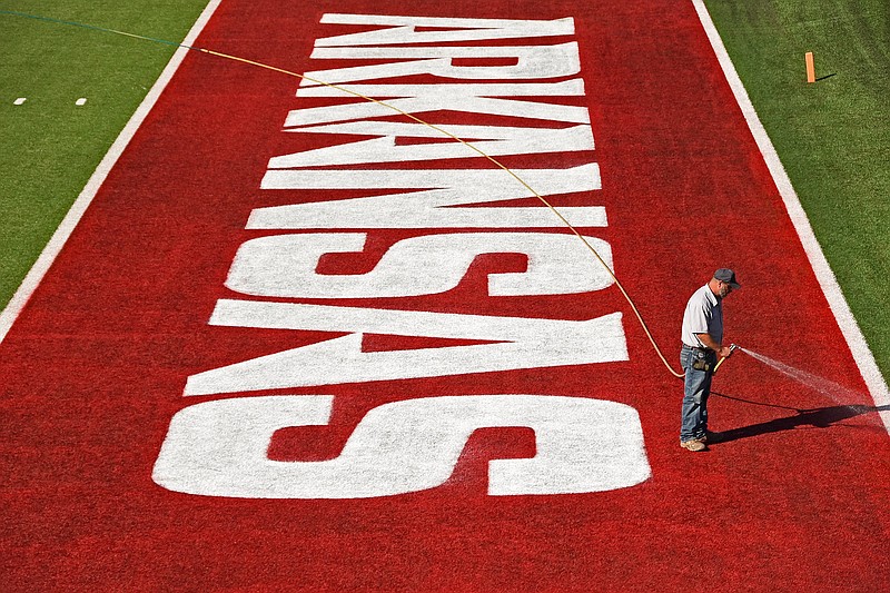 A worker sprays down the end zone Friday morning while preparing War Memorial Stadium for today’s college football game between the Arkansas Razorbacks and the University of Arkansas at Pine Bluff Golden Lions. This is the Razorbacks’ first in-state opponent since 1944.
(Arkansas Democrat-Gazette/Staci Vandagriff)