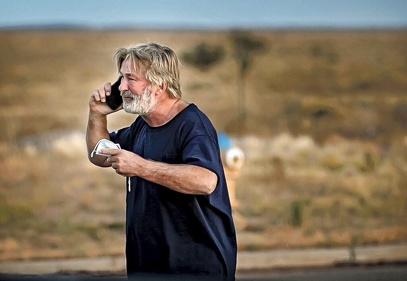 Alec Baldwin speaks on the phone in the parking lot outside the Santa Fe County Sheriff's Office in Santa Fe, N.M., after he was questioned about a shooting on the set of the film "Rust" on the outskirts of Santa Fe, Thursday, Oct. 21, 2021. (Jim Weber/Santa Fe New Mexican via AP)