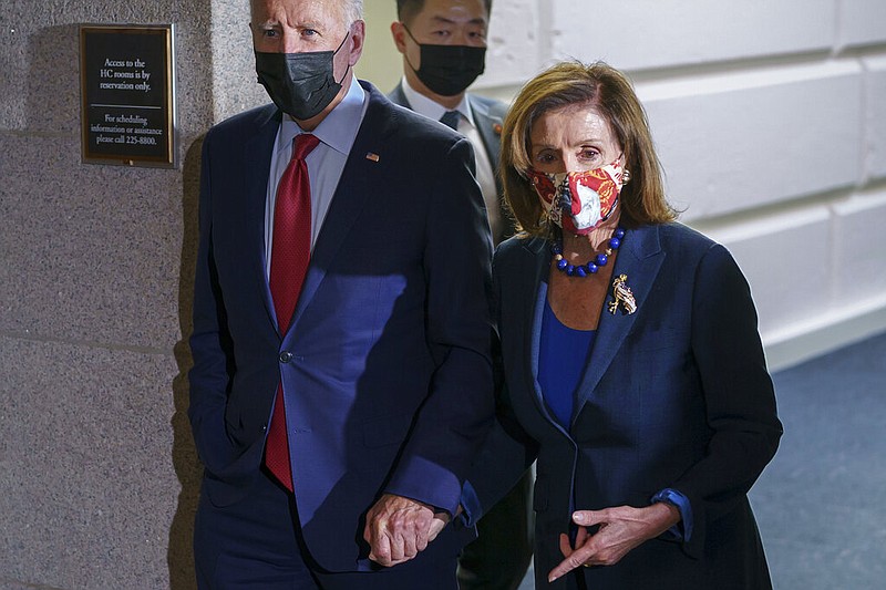 In this Oct. 1, 2021 photo, President Joe Biden and Speaker of the House Nancy Pelosi, D-Calif., walk in a basement hallway of the Capitol after meeting with House Democrats, on Capitol Hill in Washington. (AP/J. Scott Applewhite)
