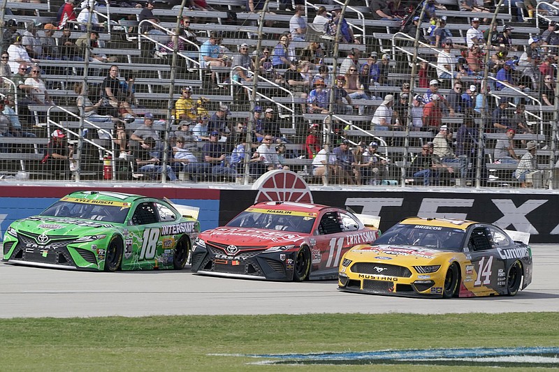 Kyle Busch, Denny Hamlin (middle) and Chase Briscoe (14) race 3-wide during last week’s race at Texas Motor Speedway in Fort Worth. When Briscoe — who is not in playoff contention — raced Hamlin hard last week, Hamlin fumed about a lack of situational awareness. “There’s cars racing for a championship,” Hamlin wrote to Briscoe on Instagram. “Perhaps when you learn give and take you will start to finish better.”
(AP/Larry Papke)