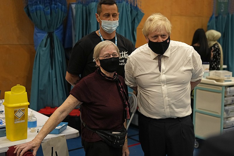 British Prime Minister Boris Johnson poses for a photo Friday with 88-year-old Nitza Sarner after she received a Pfizer booster vaccination. Johnson was visiting a covid-19 vaccination center at the Little Venice Sports Centre in London.
(AP/Matt Dunham)