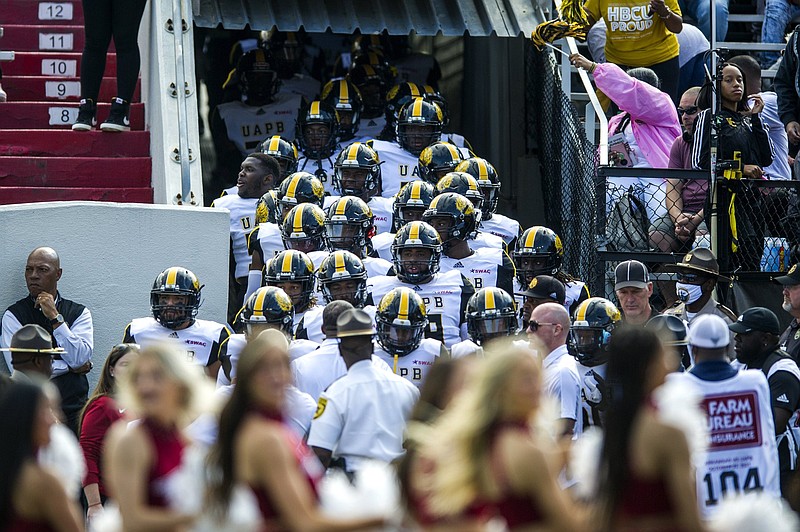 Players from the University of Arkansas at Pine Bluff walk on to the field at War Memorial Stadium in Little Rock before Saturday’s game against the University of Arkansas. UAPB was the first in-state opponent Arkansas had played in football since 1944 when the Razorbacks faced the University of Arkansas at Monticello, then known as Arkansas A&M.
(Arkansas Democrat-Gazette/Stephen Swofford)