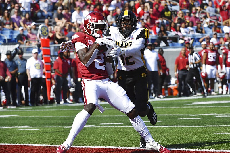 Arkansas receiver Ketron Jackson Jr. (2) makes a touchdown catch in front of University of Arkansas-Pine Bluff defensive back Nathan Seward (12) during the first half in Little Rock on Saturday, Oct. 23, 2021. (AP/Michael Woods)