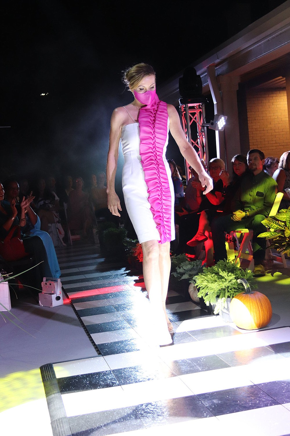 A white dress with pink ruffle accents is one of the creations of graduate designer Beth Hollar.  (Arkansas Democrat-Gazette / Helaine R. Williams)