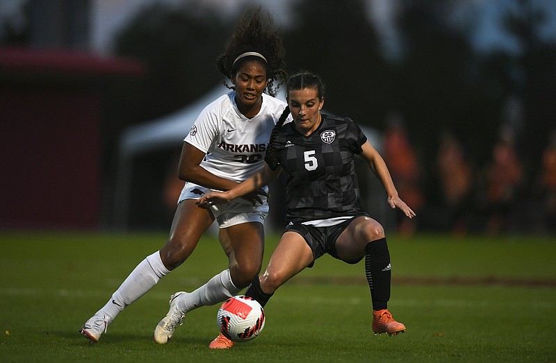 Arkansas defender Bryana Hunter (left) and Mississippi State midfielder Ally Perry fight for possession during Sunday’s game at Razorback Field in Fayetteville. Hunter scored the second goal for the Razorbacks in a 2-0 victory, their school-record 14th in a row. More photos at arkansasonline.com/1025msuua
(NWA Democrat-Gazette/Charlie Kaijo)