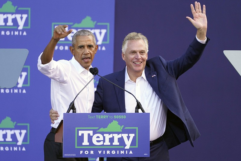 Former President Barack Obama waves to the crowd along with the Virginia Democratic gubernatorial candidate, former Gov. Terry McAuliffe, during a rally Saturday in Richmond, Va. Video at arkansasonline.com/1025obamava/.
(AP/Steve Helber)