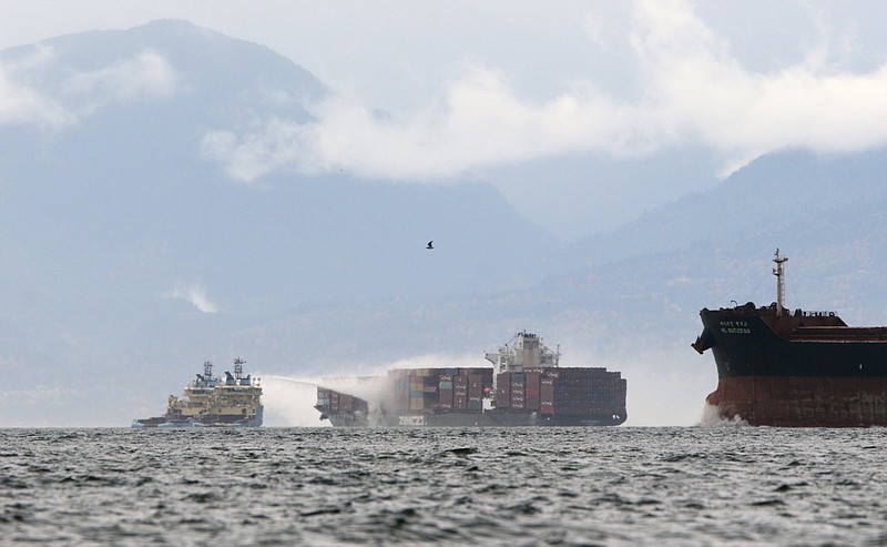 Ships’ crews work to control a fire Sunday aboard the MV Zim Kingston about 5 miles offshore from Victoria, British Columbia.
(AP/The Canadian press/Chad Hipolito)