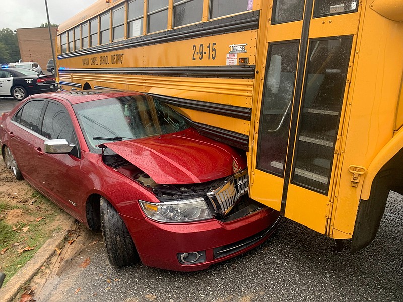 A red four-door vehicle is caught under a lower panel of a Watson Chapel School District bus Thursday on the corner of West 28th Avenue and Apple Street following a collision.
(Special to The Commercial/Andrew Curry)