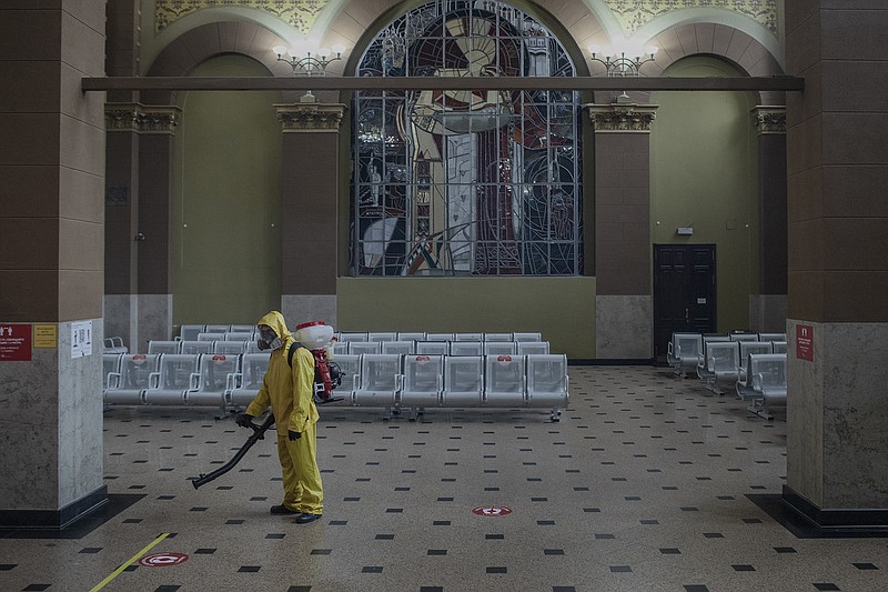 A worker disinfects a railway station Thursday in Moscow as the city enters a partial lockdown.
(The New York Times/Emile Ducke)