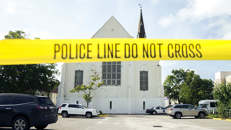FILE - In this June 19, 2015 file photo, police tape surrounds the parking lot behind the AME Emanuel Church as FBI forensic experts work the crime scene, in Charleston, S.C. (AP/Stephen B. Morton, File)