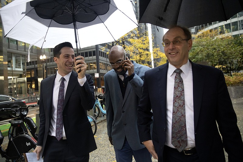 Eddie Bolden, flanked by attorneys Eli Litoff (left) and Ron Safer, talks to his aunt Friday as he leaves a courthouse in Chicago after being awarded $25.2 million in a wrongful conviction case.
(AP/Chicago Tribune/Erin Hooley)