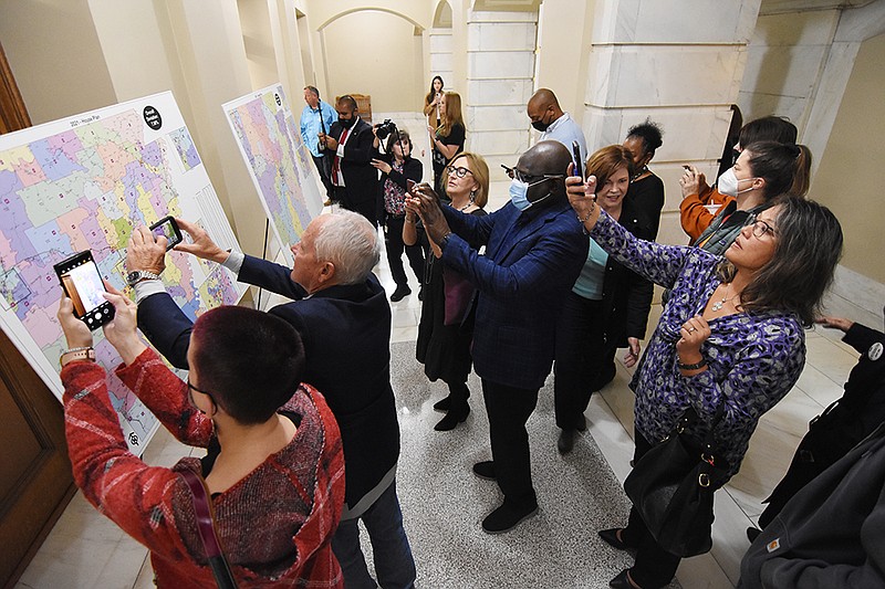 FILE - People crowd the new state legislative redistricting maps to get pictures after the Arkansas Board of Apportionment voted to accept them Friday, Oct. 29, 2021, at the state Capitol. (Arkansas Democrat-Gazette/Staci Vandagriff)