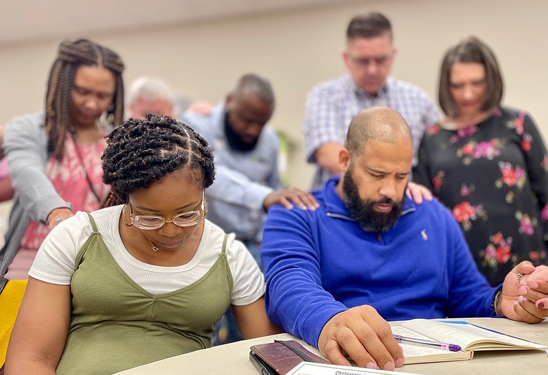 Arkansas Baptists pray for Ahmad Muqtasid and his wife, Tagel, during a Mission Connection Meet and Greet Dinner on Sunday at First Baptist Church in Jacksonville. The Muqtasids have focused their ministry on Maumelle apartment complex dwellers.
(Arkansas Democrat-Gazette/Frank E. Lockwood)