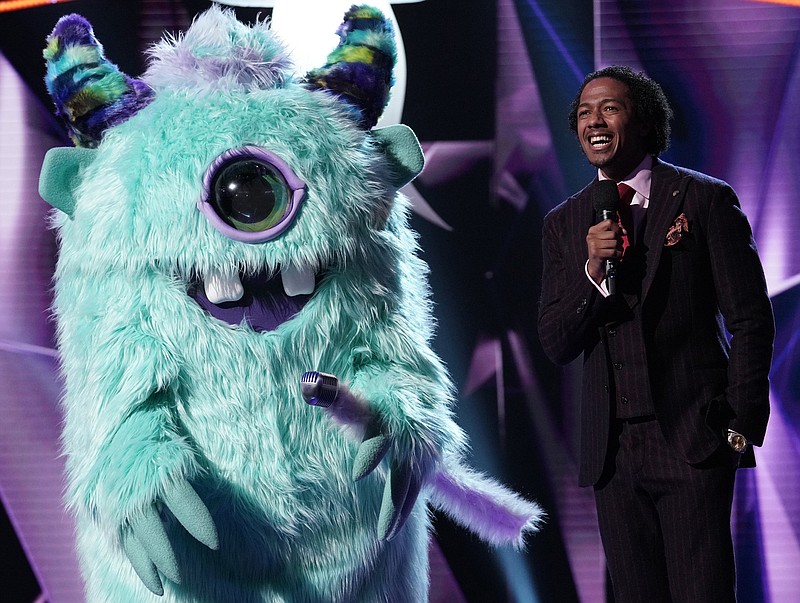 Host Nick Cannon (right) joins a "monster" in the Jan. 2, 2019, series premiere of "The Masked Singer" on FOX. 
(FOX Broadcasting/Michael Becker)