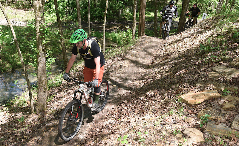 FILE — Bikers pedal along the new Monument Trail system at Devil's Den State Park south of West Fork after dedication ceremonies at the trailhead in this May 6, 2021 file photo. (NWA Democrat-Gazette/Flip Putthoff)