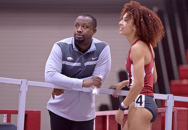 Arkansas assistant track coach Chris Johnson (left) speaks with Taliyah Brooks during the Tyson Invitational on Friday, Feb. 10, 2017, in Fayetteville.