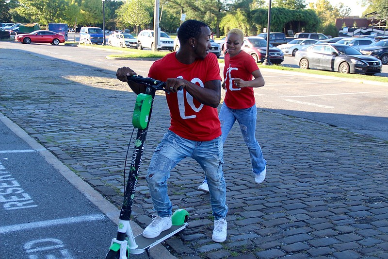 Derrio Ice and Leslie Alexander get ready to explore downtown Little Rock recently on one of the electric motorized scooters that are available to rent. 
(Pine Bluff Commercial/Eplunus Colvin)