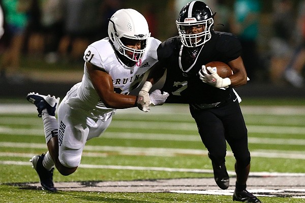 Pulaski Academy defensive end Romelo Bell (21) chases down White Hall running back Zaire Green (7) during the first quarter of Pulaski Academy's 63-28 win on Friday, Oct. 8, 2021, at Bulldog Stadium in White Hall.