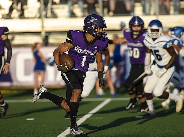 Fayetteville receiver Isaiah Sategna runs with the ball during a game against Conway on Friday, Aug. 27, 2021, in Fayetteville.