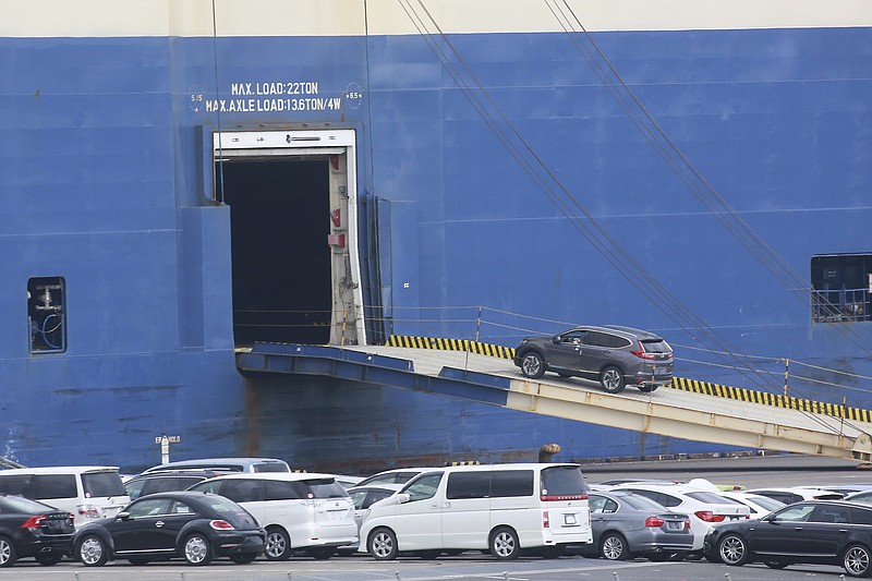 Cars for export are loaded onto a cargo ship at a port in Yokohama on Tuesday. The U.S. trade deficit hit an all-time high of $80.9 billion in September as American exports fell sharply.
(AP/Koji Sasahara)