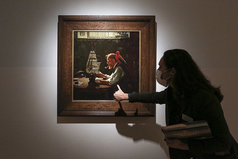 Curator Austen Barron Bailly discusses the painting “For a Good Boy” by Norman Rockwell at Crystal Bridges Museum of American Art in Bentonville on Thursday. Crystal Bridges held a media preview of “In American Waters: The Sea in American Painting.”
(NWA Democrat-Gazette/Charlie Kaijo)