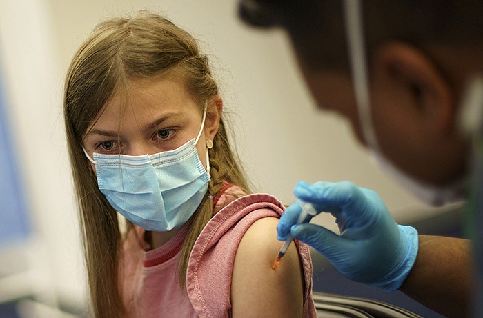 Lorelei Znoj, 10, gets a Pfizer covid-19 shot Thursday at a staterun site in Cranston, R.I. In Arkansas, demand for the vaccine for children ages 5-11 “is currently high,” and shipments are going out, state Department of Health spokeswoman Danyelle McNeill said.
(AP/David Goldman)