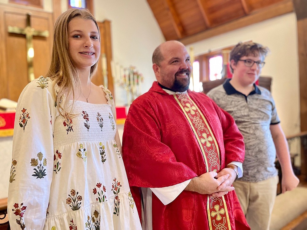 Pastor Kent Schaaf of Grace Lutheran Church in Little Rock stands with Emma Schnackenberg of Little Rock and Isaac Goodrich of Conway on the day of their confirmation. The two catechumens Sunday renounced the devil, affirmed the Apostle’s Creed and promised “to live according to the Word of God.”