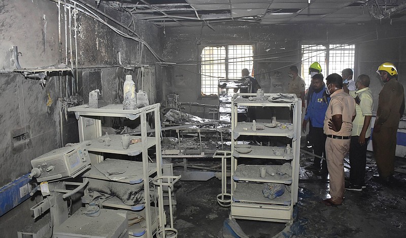 People inspect the covid-19 ward after Saturday’s fire at a hospital in Ahmednagar, India.
(AP)