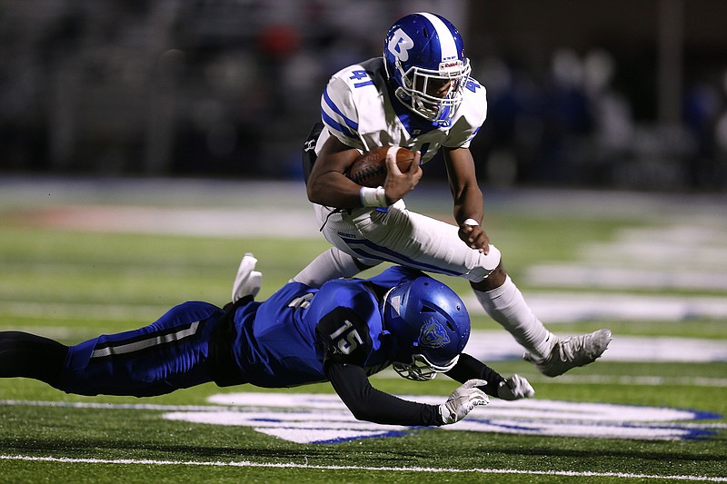 Bryant running back Chris Gannaway (41) dives over Conway safety Trey Roberts (15) during the second quarter of Bryant's 32-29 win on Friday, Nov. 5, 2021, at John McConnell Stadium in Conway. .(Arkansas Democrat-Gazette/Thomas Metthe)
