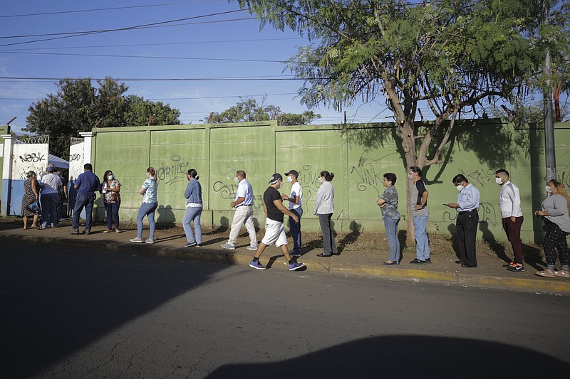 Voters wait in line Sunday during general elections in Managua, Nicaragua. More photos at arkansasonline.com/118managua/.
(AP/Andres Nunes)