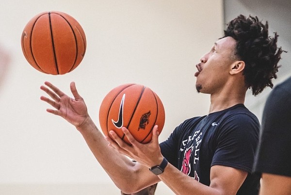 Arkansas sophomore Jaylin Williams juggles basketballs, which is part of the Razorbacks’ pregame warmup routine that was instituted by Coach Eric Musselman, who learned it from father.
(Photo courtesy of the University of Arkansas)