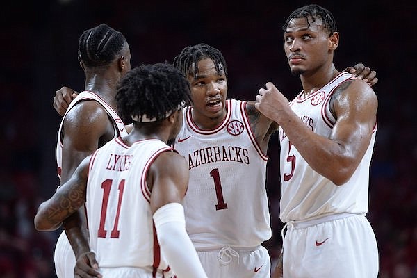 Arkansas guard JD Notae (1) speaks Tuesday, Nov. 9, 2021, with teammates guard Davonte Davis, (from left) guard Chris Lykes and guard Au'Diese Toney during the second half of the Razorbacks' 74-61 win over Mercer in Bud Walton Arena in Fayetteville.