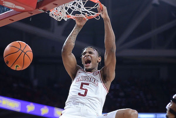 Arkansas guard Au'Diese Toney dunks the ball during a game against Mercer on Tuesday, Nov. 9, 2021, in Fayetteville.