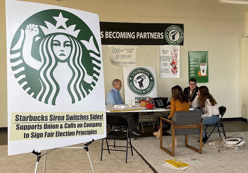 Richard Bensinger (left), who is advising unionization efforts, meets with Starbucks baristas to discuss their efforts to unionize three Buffalo, N.Y.,-area stores in this October file photo.
(AP)