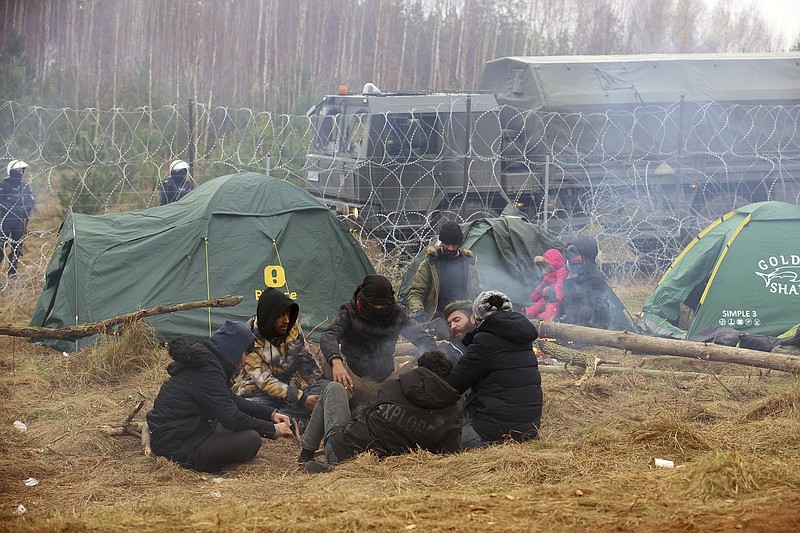 Migrants gather around a fire to keep warm Wednesday near Grodno, Belarus, on the nation’s border with Poland. More photos at arkansasonline.com/1111belarus/.
(AP/BelTA/Leonid Shcheglov)
