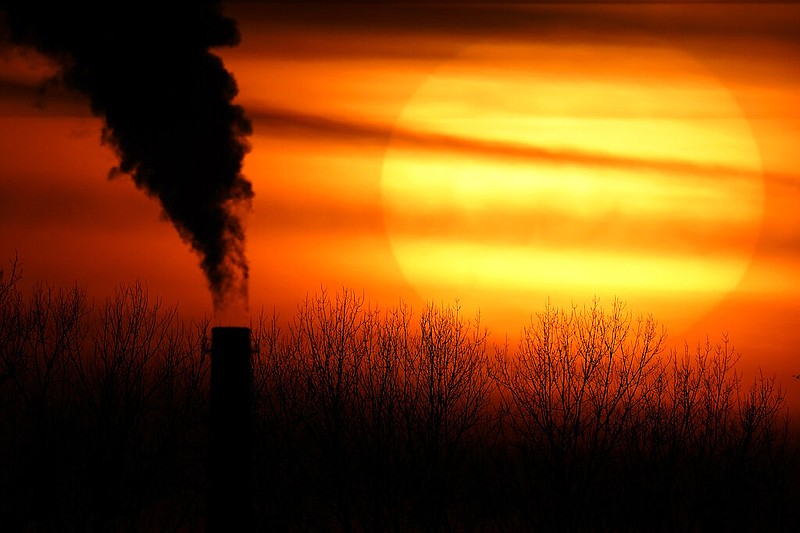 FILE - Emissions from a coal-fired power plant are silhouetted against the setting sun, Monday, Feb. 1, 2021, in Independence, Mo. (AP/Charlie Riedel, File)