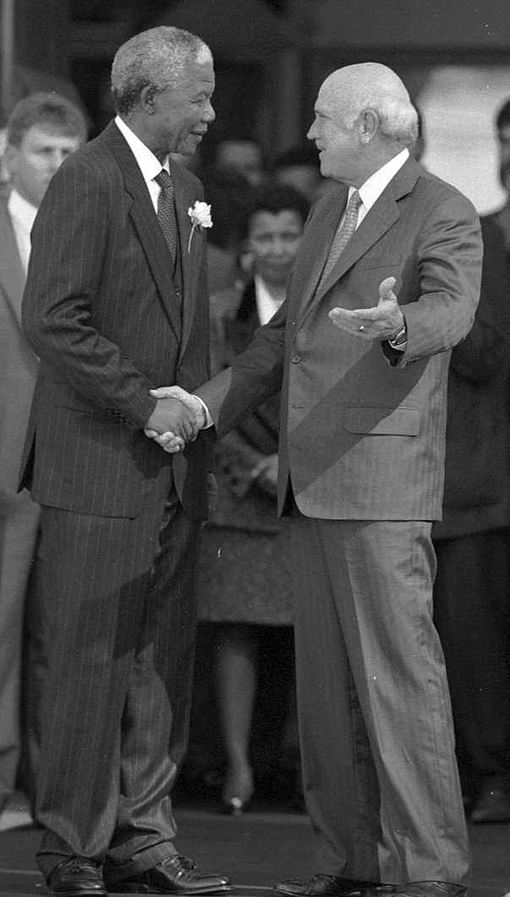 F.W. de Klerk shakes hands with new President Nelson Mandela in Pretoria, South Africa, on May 9, 1994, after the inauguration of the post-apartheid transitional government. More photos at arkansasonline.com/1112deklerk/.
(The New York Times/Ozier Muhammad)
