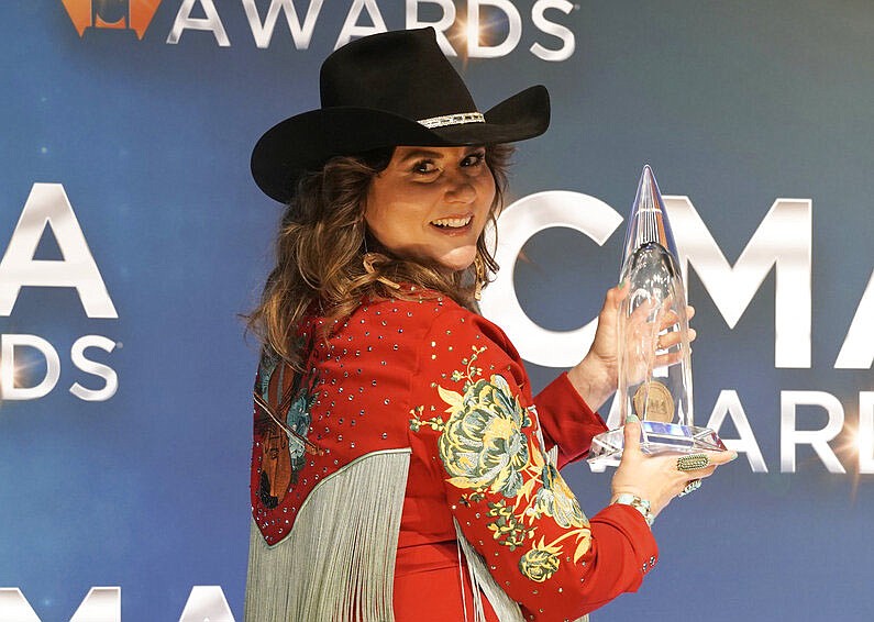 Jenee Fleenor poses in the press room with the award for Musician of the year for Fiddle at the 55th annual CMA Awards on Wednesday, Nov. 10, 2021, at the Bridgestone Arena in Nashville, Tenn. (AP Photo/Ed Rode)