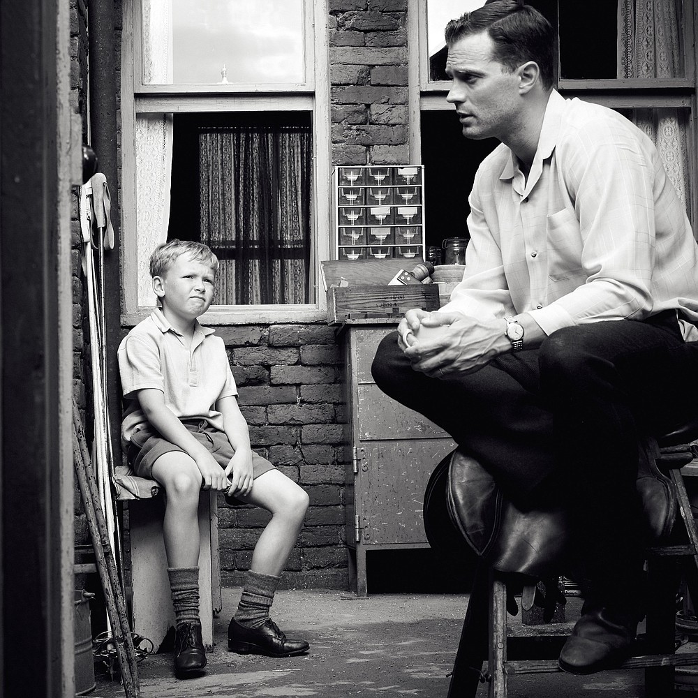 Buddy (Jude Hill) and his father, Pa (Jamie Dornan) perform in Kenneth Branagh’s “Belfast,” a semi-autobiographic film about a working class family and their young son’s childhood during The Troubles in Northern Ireland.