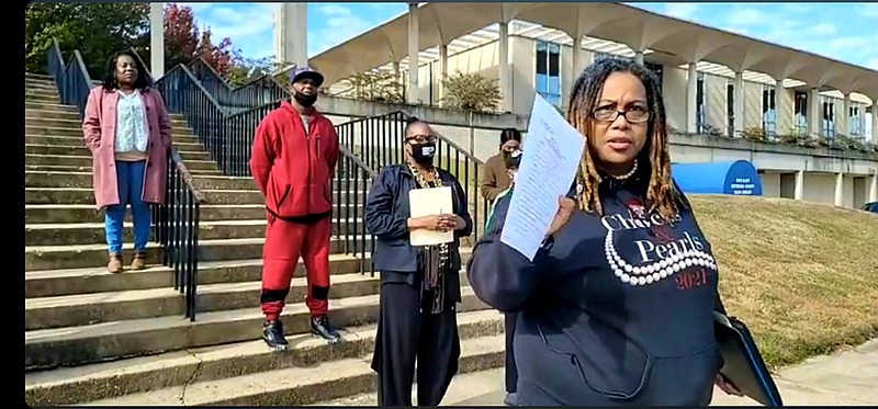 During a news conference Friday, Pine Bluff Social Justice Activists member Kymara Seals presents a letter that was written in 2019 from Mayor Shirley Washington to Street Department Director Rich Rhoden addressing his perceived prejudicial behavior. 
(Pine Bluff Commercial/Eplunus Colvin)