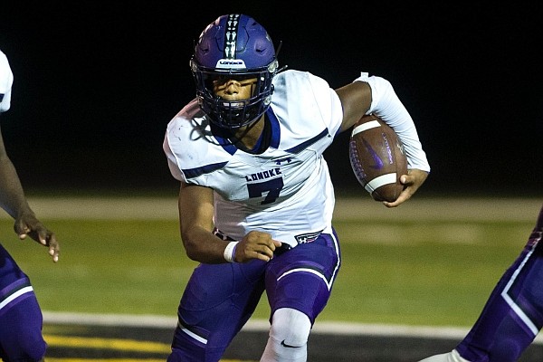 Lonoke quarterback Bradon Allen (middle) runs through a gap created by his offensive line Friday during the Jackrabbits’ 35-6 victory over the Mills Comets. Allen ran 21 times for 154 yards and 3 touchdowns.