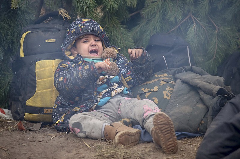 A child cries as other migrants from the Middle East and elsewhere gather Friday at the Belarus-Poland border near Grodno, Belarus. More photos at arkansasonline.com/1113belarus/.
(AP/BelTA/Leonid Shcheglov)