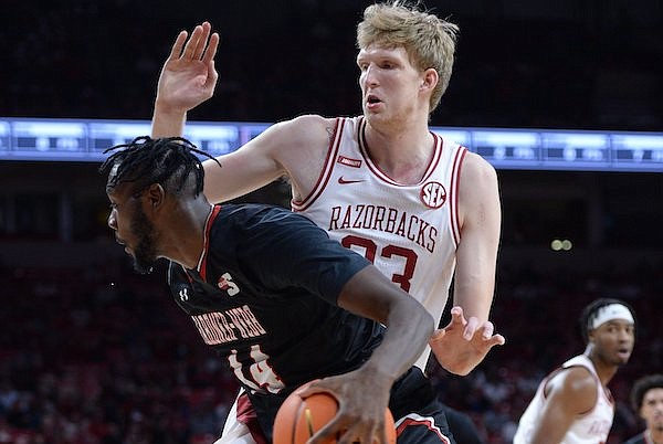 Gardner-Webb forward Kareem Reid (14) makes a move to the basket Saturday, Nov. 13, 2021, as Arkansas forward Connor Vanover (top) moves to block out during the first half of play in Bud Walton Arena.