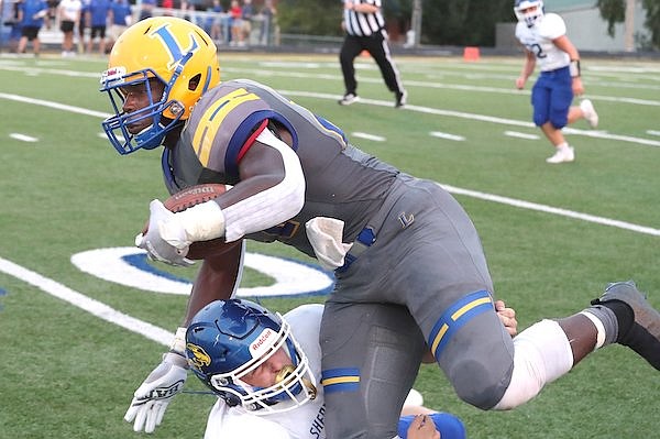 Hot Springs Lakeside running back Braylen Russell (27) is tackled by Sheridan's Wesley Shumate during a game Friday, Sept. 3, 2021, in Hot Springs.