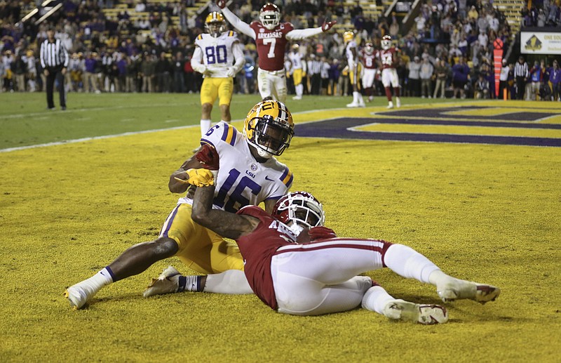 Arkansas defensive back Montaric Brown (21) intercepts a pass intended for LSU wide receiver Devonta Lee (16), Saturday, November 13, 2021 during overtime of a football game at Tiger Stadium in Baton Rouge, La. Check out nwaonline.com/211114Daily/ for today's photo gallery. .(NWA Democrat-Gazette/Charlie Kaijo)