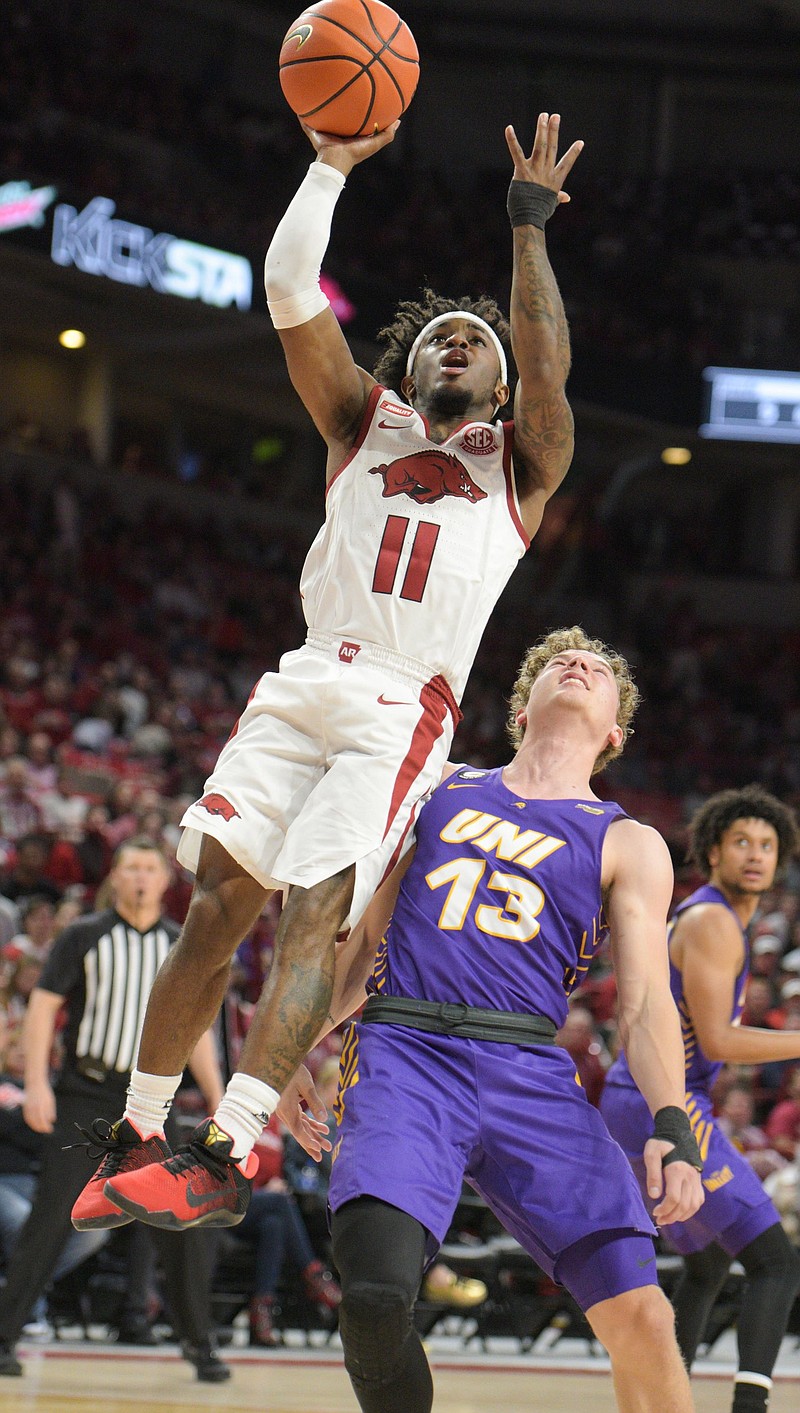 Arkansas’ Chris Lykes drives to the basket in front of Northern Iowa’s Bowen Born during the Razorbacks’ victory Wednesday night at Walton Arena in Fayetteville. Lykes led all scorers with 26 points.
(NWA Democrat-Gazette/Hank Layton)