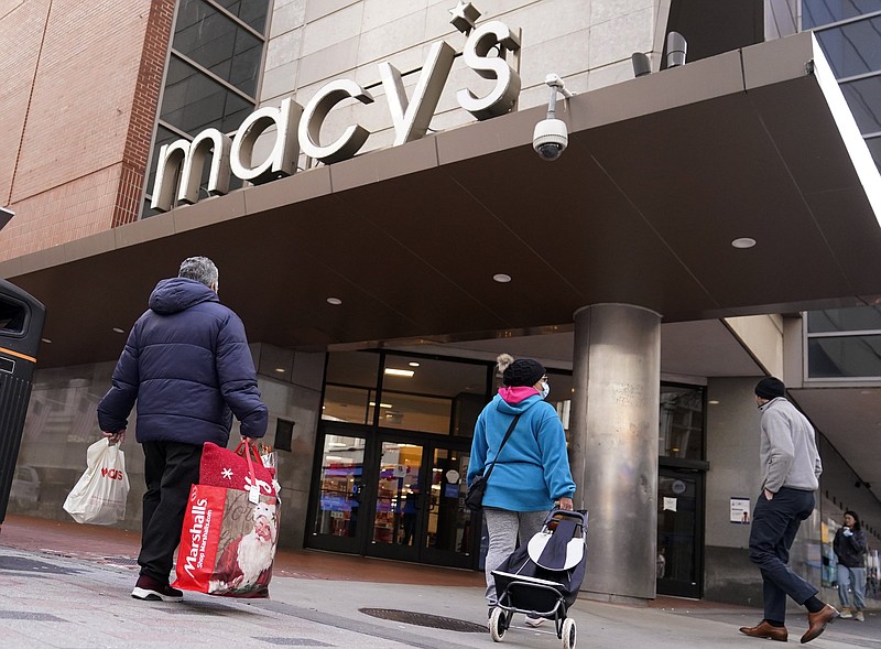 Shoppers walk to the Macy’s store in the Downtown Crossing district on Wednesday in Boston. Macy’s Inc. reported fiscal third-quarter net income of $239 million on Thursday.
(AP/Charles Krupa)