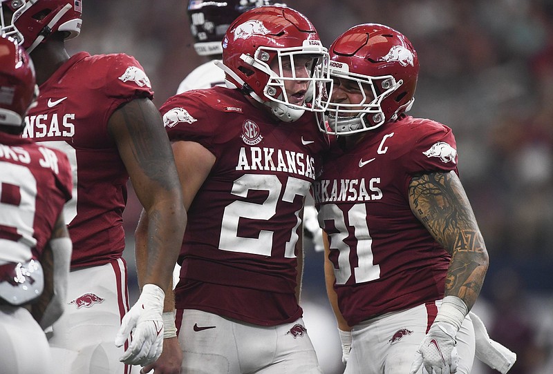 Linebackers Hayden Henry (27) and Grant Morgan (31) are among several Arkansas players who were allowed to return this season because of the NCAA’s relaxed eligibility regulations because of the covid-19 pandemic and have had an impact during the Razorbacks’ resurgence.
(NWA Democrat-Gazette/Charlie Kaijo)