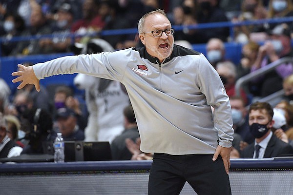 Arkansas head coach Mike Neighbors reacts in the first half of an NCAA college basketball game against Connecticut, Sunday, Nov. 14, 2021, in Hartford, Conn. (AP Photo/Jessica Hill)