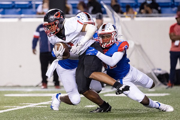 Parkview's Omarion Robinson (39) tackles Russellville's Tracy Daniels (1) during a game Thursday, Oct. 21, 2021, at War Memorial Stadium in Little Rock.